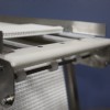 Inside the frame of a stainless steel conveyor